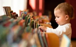 a child looking at a bunch of books