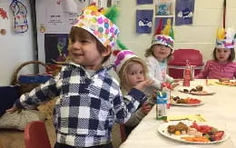 a group of children wearing party hats