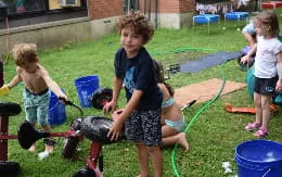 children playing with a hose