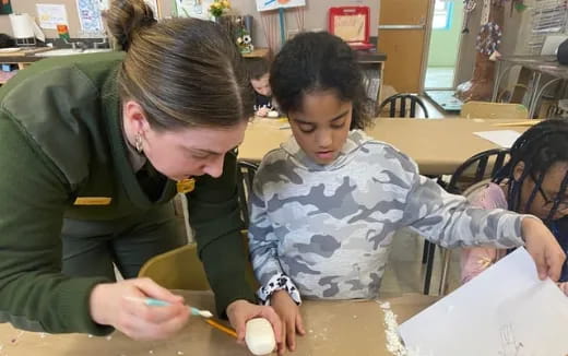 a person and a child sitting at a table