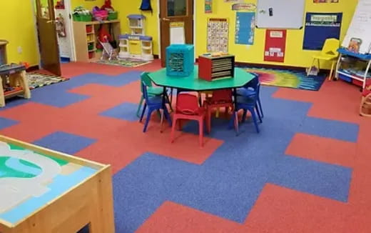 a child's playroom with a table and chairs