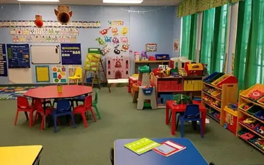 a classroom with colorful desks and chairs