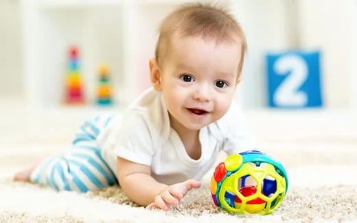 a baby playing with a toy