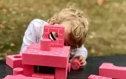 a little girl playing with a toy