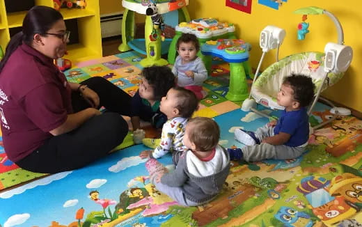 a person and several children sitting on the floor