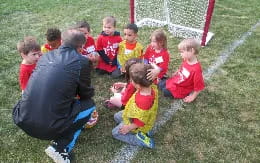 a group of kids sitting on the grass