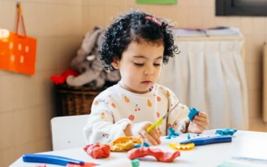 a baby sitting at a table