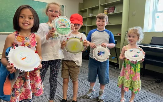 a group of children holding plates