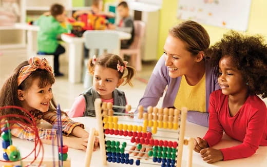 a person and several children painting