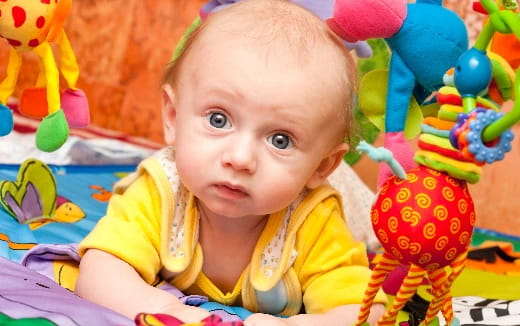 a baby lying on a blanket