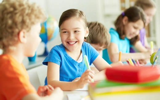 a group of children sitting at a table