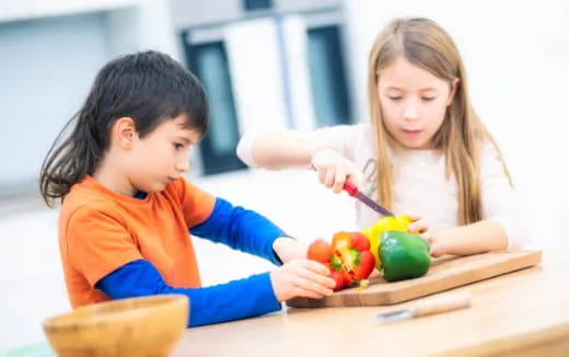 a boy and girl painting tomatoes