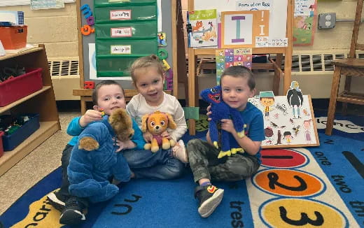 a group of kids holding stuffed animals