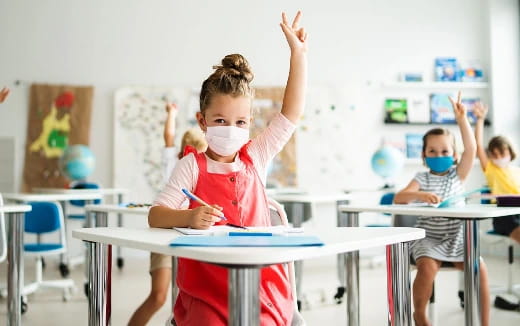 a young girl raising her hands