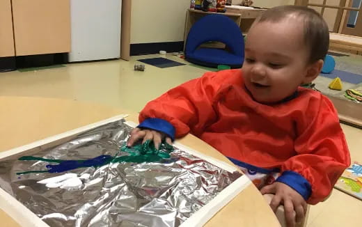 a baby playing with plastic toys