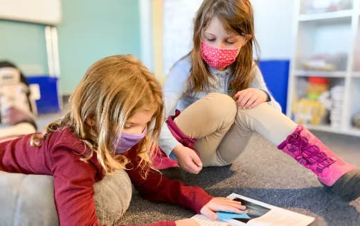 a couple of girls wearing face masks