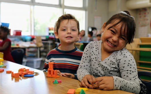 a person and a child sitting at a table