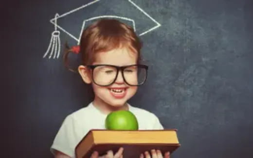 a boy holding a green apple