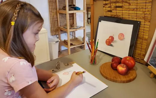 a girl painting on a table