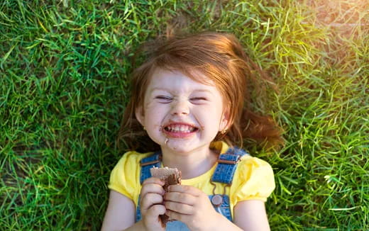 a child holding a small animal