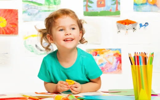 a young girl coloring on a paper