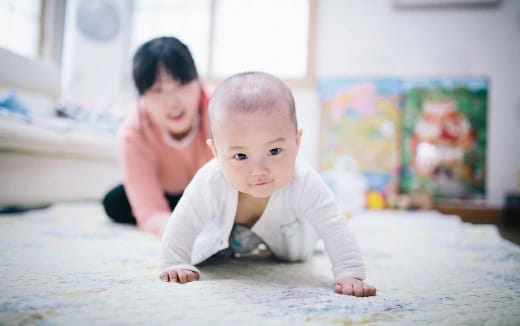 a baby crawling on the floor