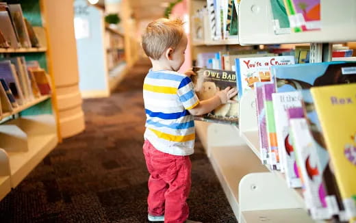 a child standing in a library