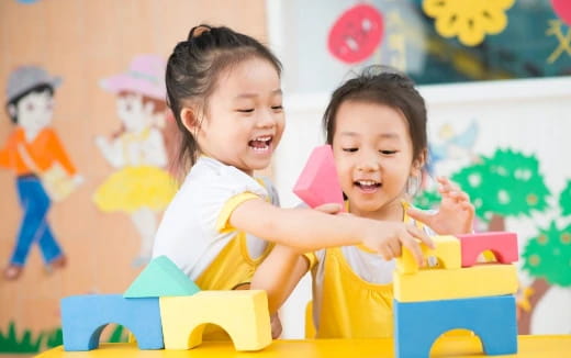 a couple of young girls playing with toys