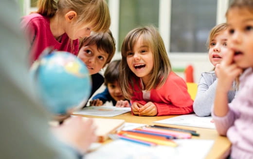 a group of children sitting at a table