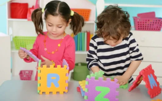 a couple of young girls playing with toys