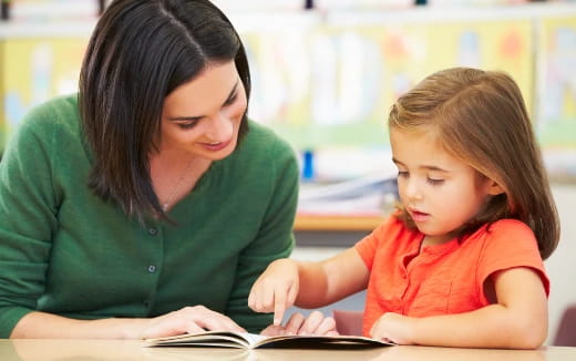 a person and a child looking at a book