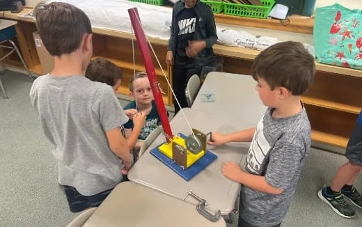 a group of kids playing with a toy train