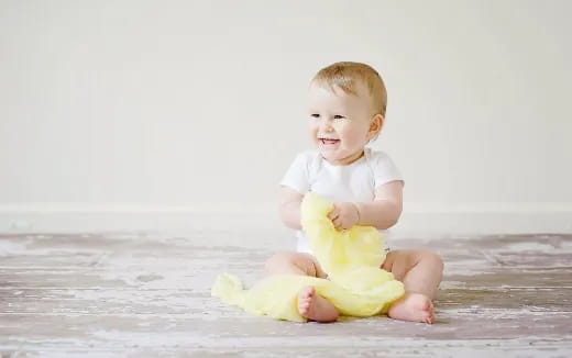 a baby sitting on the floor