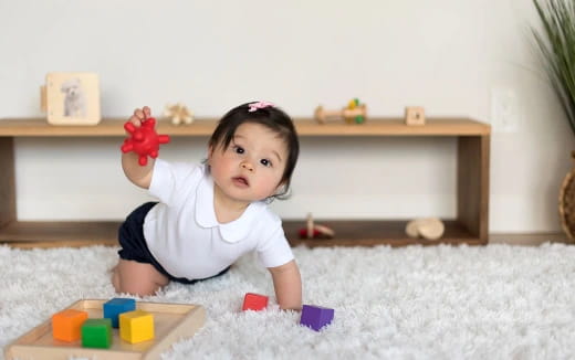 a baby lying on the floor