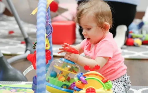 a baby playing with toys