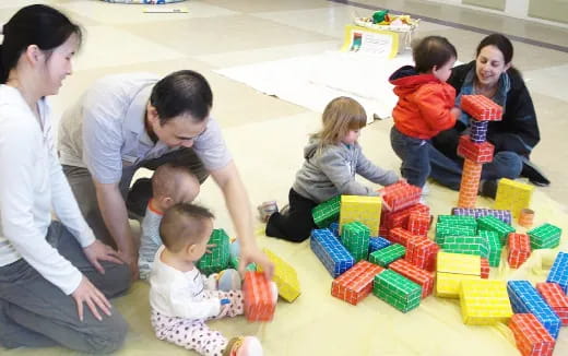 a group of people playing with toys