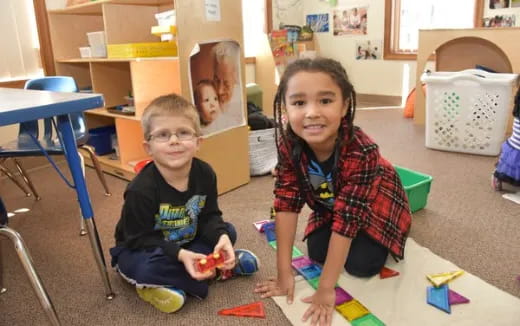 a couple of children sitting on the floor