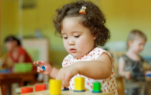 a little girl playing with toys