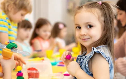 a young girl holding a toy