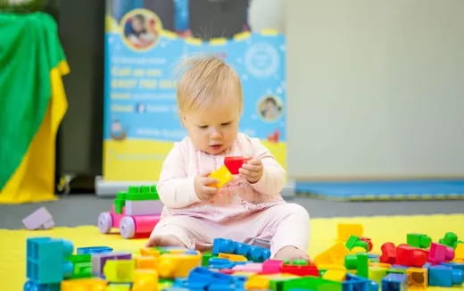 a baby sitting on the floor