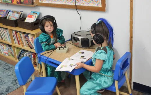 a few young girls wearing headphones