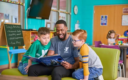 a person and two boys sitting in a classroom