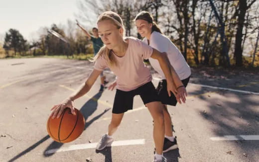 a couple of women playing basketball