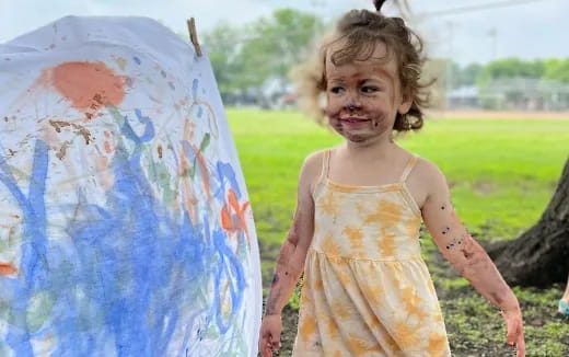 a girl holding a painting