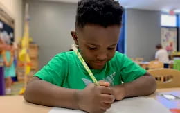 a young boy sitting at a table