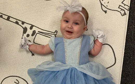 a baby in a blue dress