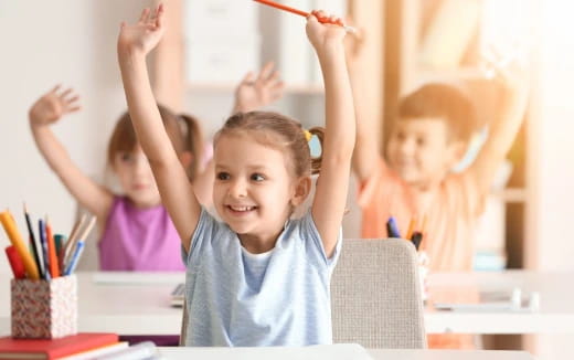 a few children raising their hands