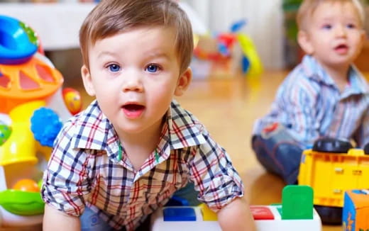 a couple of young boys playing with toys