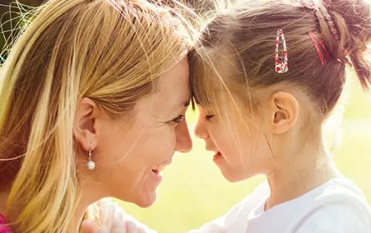 a woman whispering to another woman