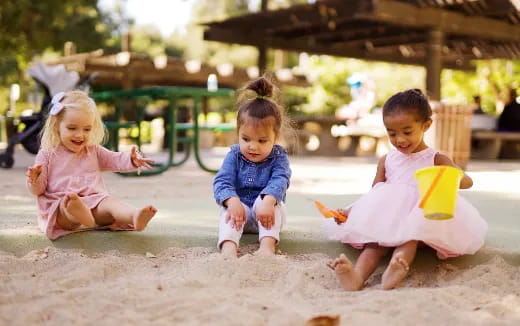 a group of children playing in sand